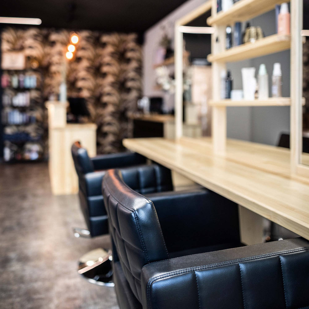 Löwenmähne Salon Friseurplatz mit Ledersessel und Spiegel